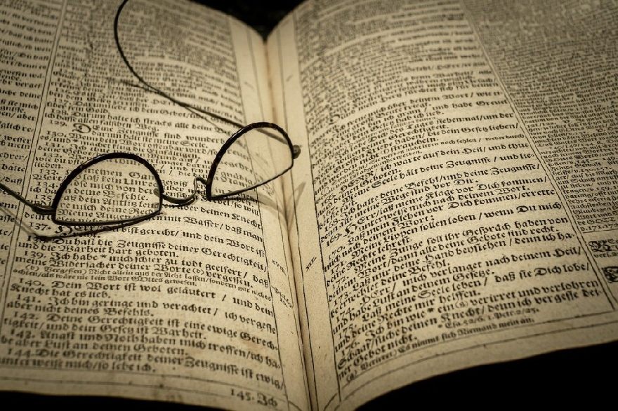 An old pair of glasses on an old Bible