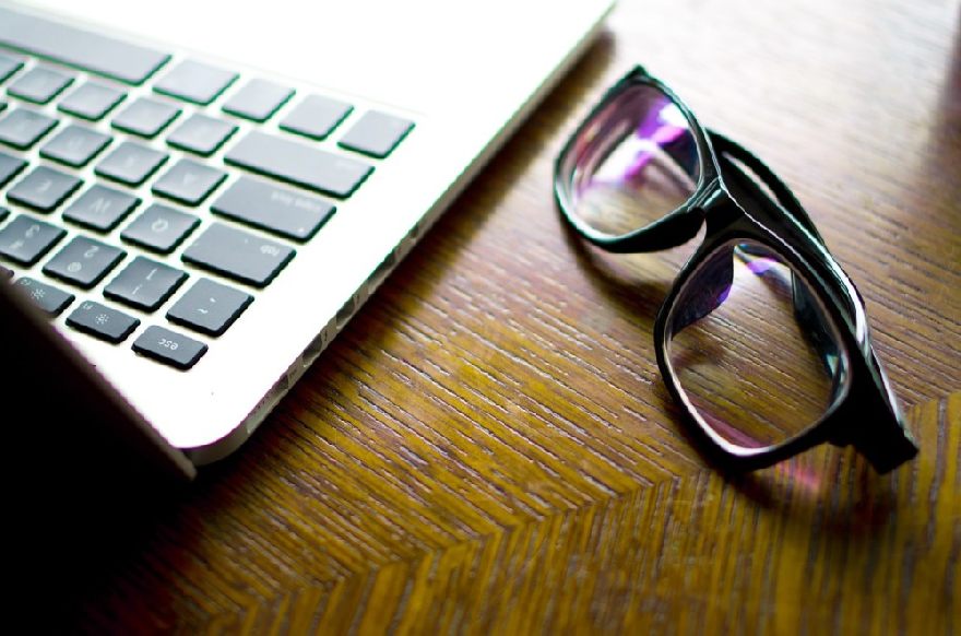 Glasses next to a notebook