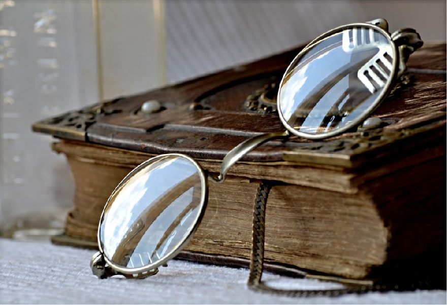 An old pair of glasses on the Bible